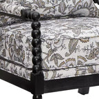 Sillón auxiliar tapizado Spool con estructura de madera torneada